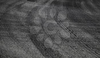 Dangerous turn. Abstract road background with tires tracks on asphalt