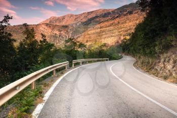 Montenegro, curved  mountain highway in soft early morning sun light