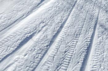 Background texture of  tire tracks on road covered with snow