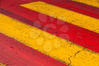 Pedestrian crossing road marking with yellow and red lines