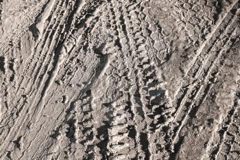 Background texture of brown road dirt with tire tracks 