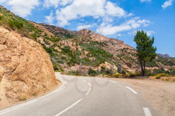 Turning mountain road with dividing line on asphalt, Corsica island, France