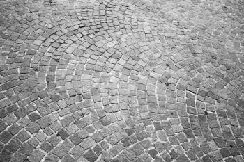 Gray granite cobblestone road pavement. Background photo texture