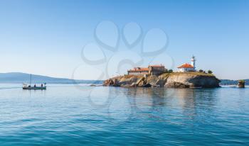 Saint Anastasia Island in Burgas bay, Black Sea, Bulgaria. Summer coastal landscape with fishermen in wooden boat 