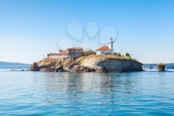 Saint Anastasia Island in Burgas bay, Black Sea, Bulgaria. Lighthouse tower and old wooden buildings on rocky coast