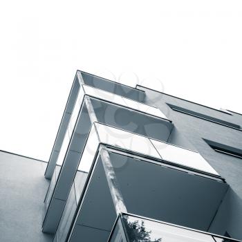 Abstract fragment of modern architecture, concrete walls and glass of balconies. Blue toned square photo