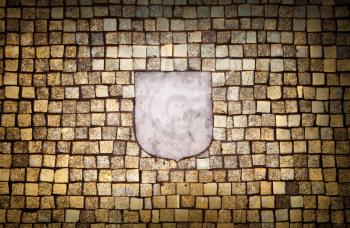 Background texture of a golden mosaic wall with an empty white marble emblem element