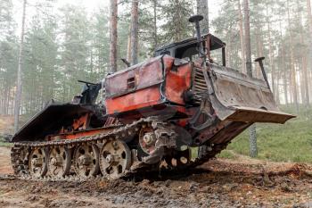 Experienced rusty all-terrain vehicle on tracks