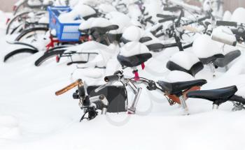 European city winter fragment. Bicycles covered with snow in big snowdrift