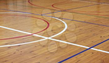 Wooden floor of sports hall with marking lines