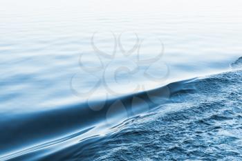 Abstract sea water background, the edge between still and wavy states