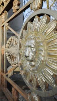 Lion head in round frame, the decoration of old metal fence in central historical part of Saint-Petersburg, Russia