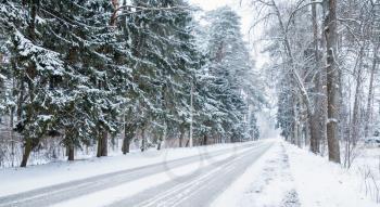 Empty snowy rural road background, cold winter season transportation