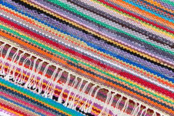 Colorful abstract patchwork rug with striped pattern, background photo texture