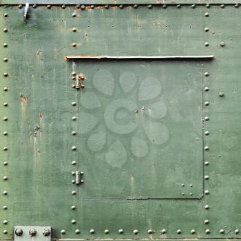 Square abstract green industrial metal background texture with bolts and rivets