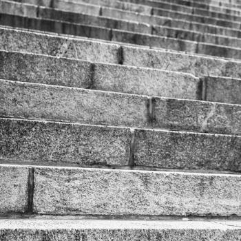 Abstract architecture fragment. Old stairway made of gray granite stone blocks, square closeup photo with selective focus