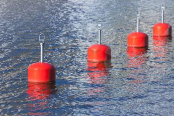 Red mooring buoys in a row, European marina nautical equipment