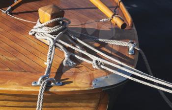 Wooden sailing ship bow fragment with bollard and mooring ropes