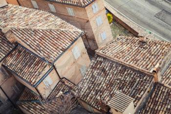 Roofs of Fermo, Italy. Old stone living houses along empty street