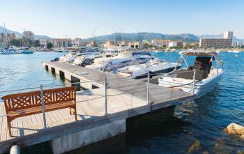 Marina of Ajaccio, the capital of Corsica, French island in the Mediterranean Sea. Floating pier with wooden bench