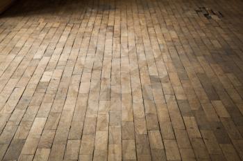 Old damaged brown wooden parquet. Background photo with perspective effect