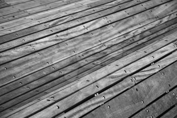 Abstract curved construction made of gray wooden planks, background with selective focus
