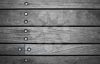 Dark gray wall made of wooden boards with bolts, background photo texture