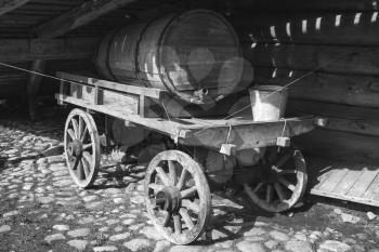 Old rural wooden cart with water tank, black and white photo