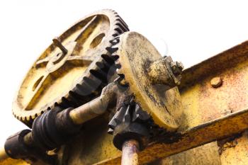 Huge old rusted gears engaged with worm-gear, close up photo isolated on white background with selective focus