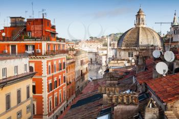 Old Rome, Italy. Via del Corso street view, photo taken from the roof, looking on The Piazza del Popolo with dome of Basilica Santa Maria di Montesanto as a dominant landmark