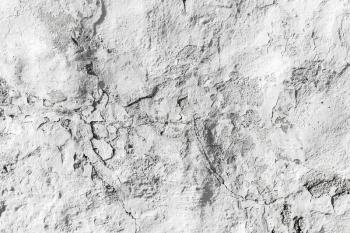 Rough white concrete wall with plaster relief pattern, background photo texture