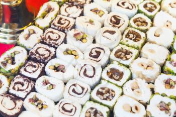 Assortment of rolled Turkish delight. Traditional cuisines of the former Ottoman Empire, photo with selective focus