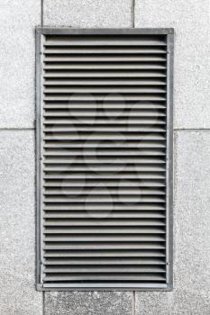 Metal ventilation grille in gray industrial wall, close up photo texture