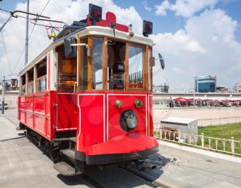 Old red tram goes on Taksim square in Istanbul, popular tourist transport