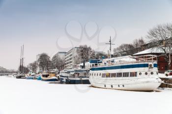 Winter cityscape of Turku, Finland. Ship restaurant moored in ice near main embankment