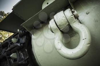 Green tank fragment. Closeup photo, heavy industry details