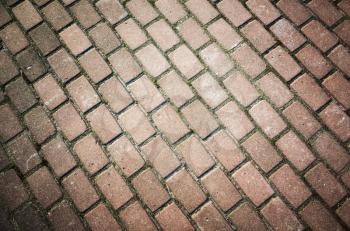 Old red cobblestone road pavement, background photo texture