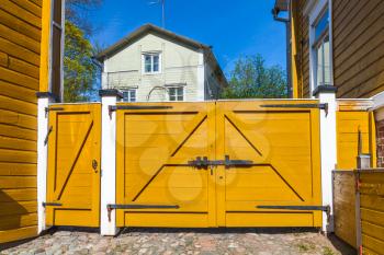 Porvoo, Finland. Old Finnish town street view. Closed yellow wooden gate