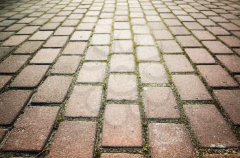 Red cobblestone road background photo with perspective effect and selective focus