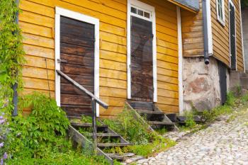 Porvoo, Finland. Old Finnish town street view. Yellow wooden houses with closed brown doors