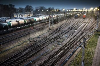 Sorting railway station with cargo trains on rails at night