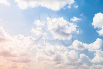 Cumulus clouds in bright sky, natural background photo
