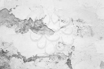 Old concrete wall with damaged plaster and white paint layer, background photo texture 