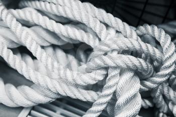 White nautical rope bundle, close up photo with blue tonal filter