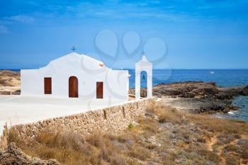 Small white Orthodox church on the Sea. Coast of island Zakynthos, Greece. Agios Nikolaos beach