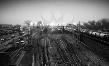 Sorting railway station with cargo trains at night, black and white photo