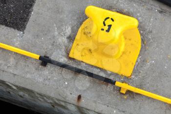 Yellow port mooring bollard with number 5 label on it