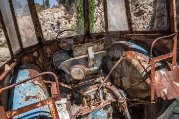 Old abandoned rusted tractor cabin interior