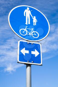 Lane for Bicycles And Pedestrians Only. Blue round road sign over blue cloudy sky background