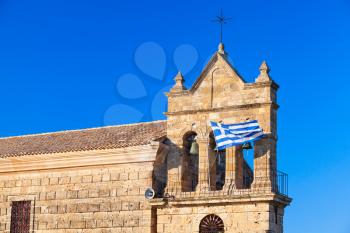 Waving Greek flag on Bell tower of Saint Nicholas Molou Church on Solomos Square. Zakynthos, Greek island in the Ionian Sea